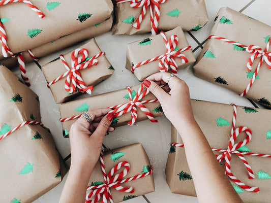 someone wrapping gifts using eco-friendly packaging